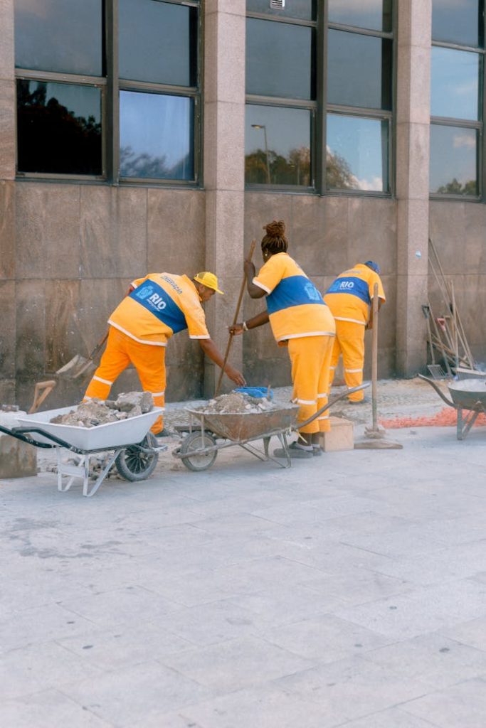 construction-workers-cleaning-the-side-of-the-building-14805531 Construction workers in uniforms working at an outdoor site in Rio de Janeiro.